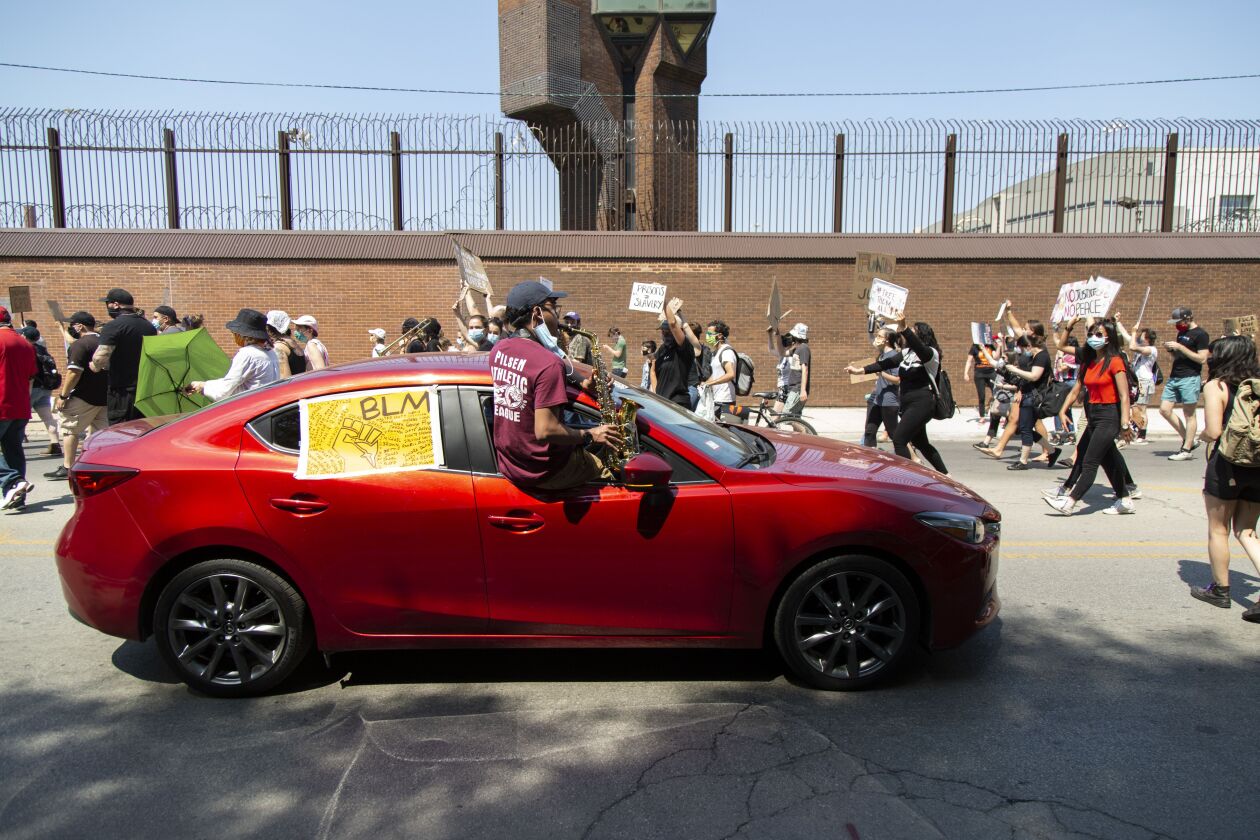 About 150 protesters on foot — as well as hundreds more in cars — gathered outside the Cook County Jail on Thursday.